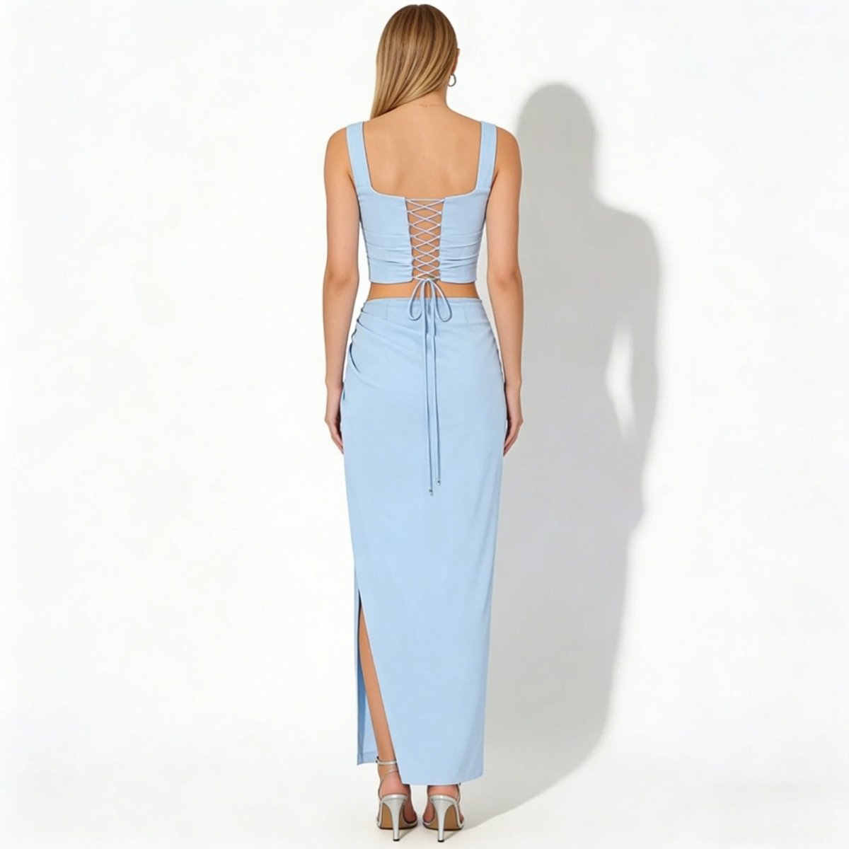 Back view of the Kouvr Rona set in light blue, highlighting the adjustable lace-up detail on the corset crop top.