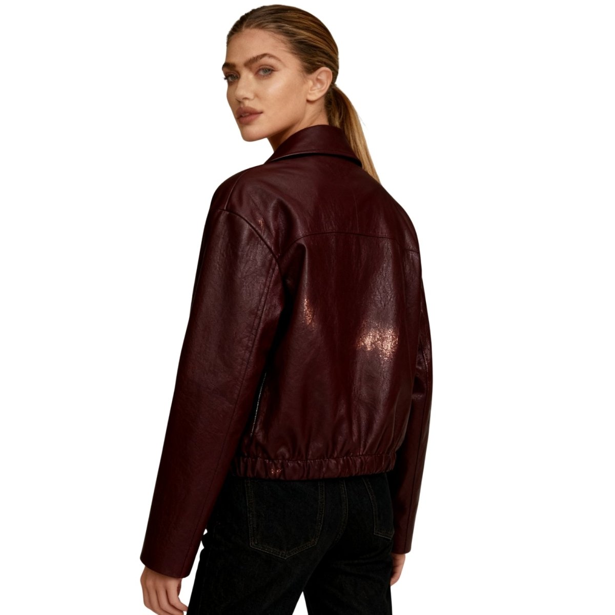 Woman wearing a Burgundy Kouvr leather jacket on a white background