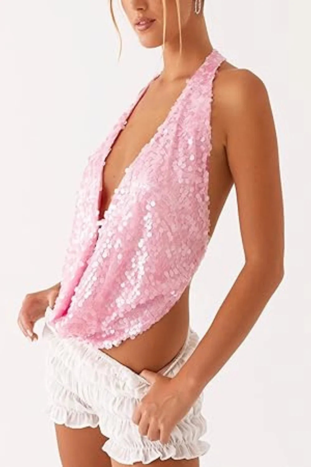Model wearing Kouvr Fashion pink sequin backless cowl neck halter top with ruched shorts