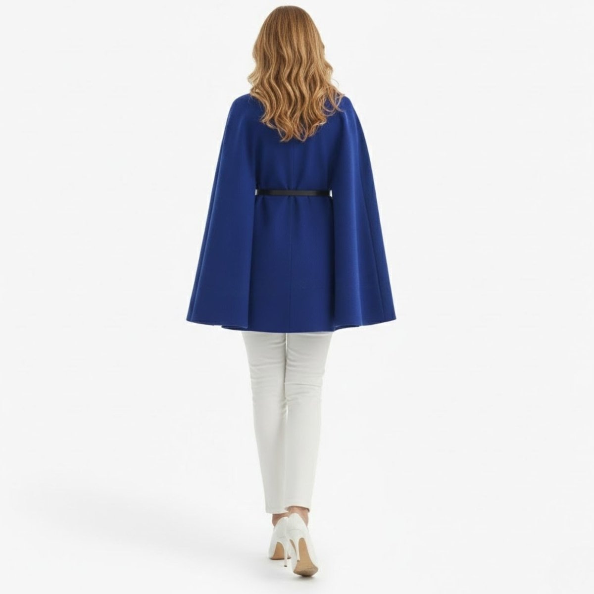 Back view of the Kouvr royal blue wool cape coat, showcasing the clean lines, belted waist, and flowing silhouette.