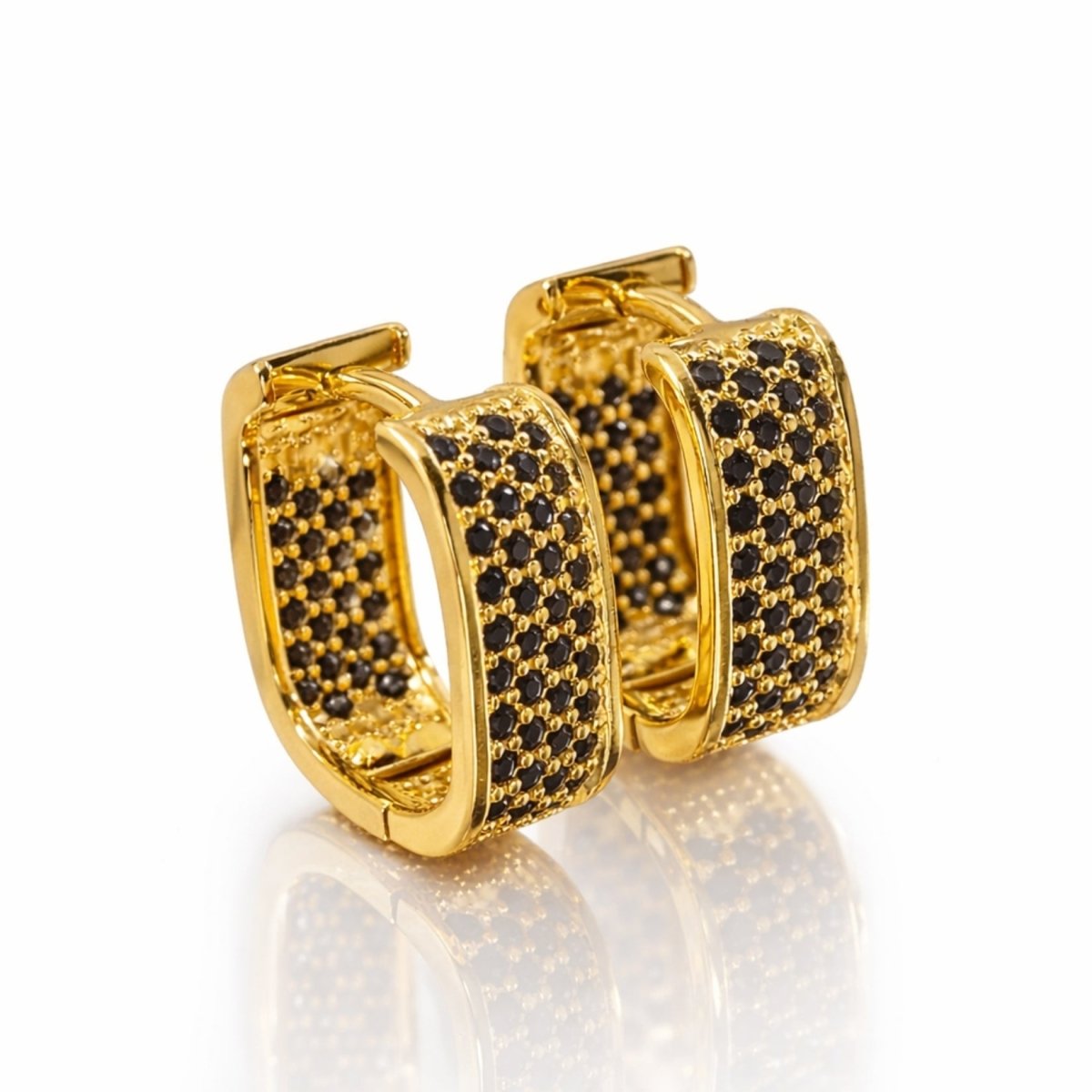 Pair of Kouvr Salome 18k gold plated U-shaped hoop earrings with three rows of black pavé stones on a clean white background with reflection.