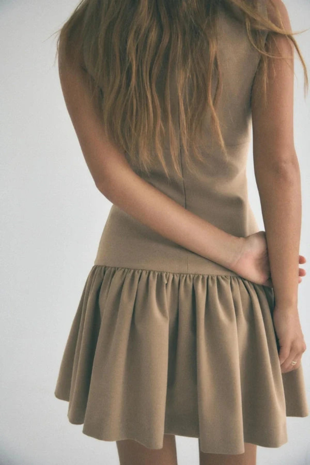 minimalist," "architectural," "modern," "fit and flare," "flounce hem," "day-to-night," and "structured fit