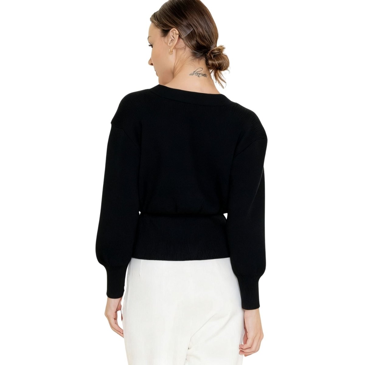  Back view of the Kouvr black blouson sleeve cardigan showing the cinched waist and ribbed knit detail. 