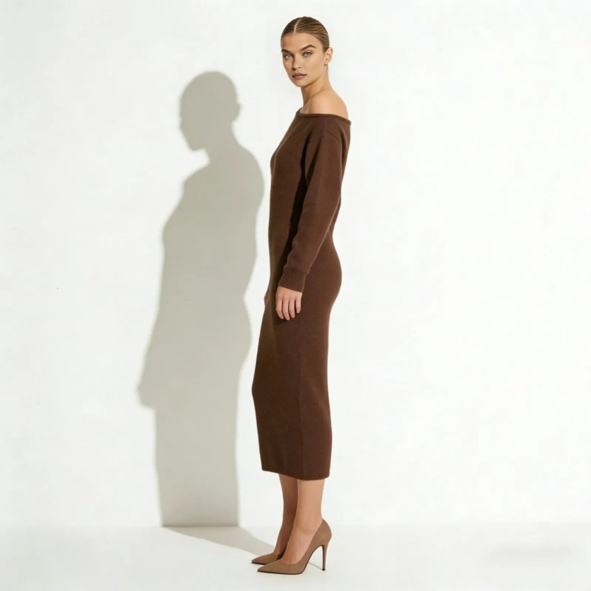 Side profile of the Selena dark brown knit midi dress, highlighting its sleek column silhouette and body-skimming fit.