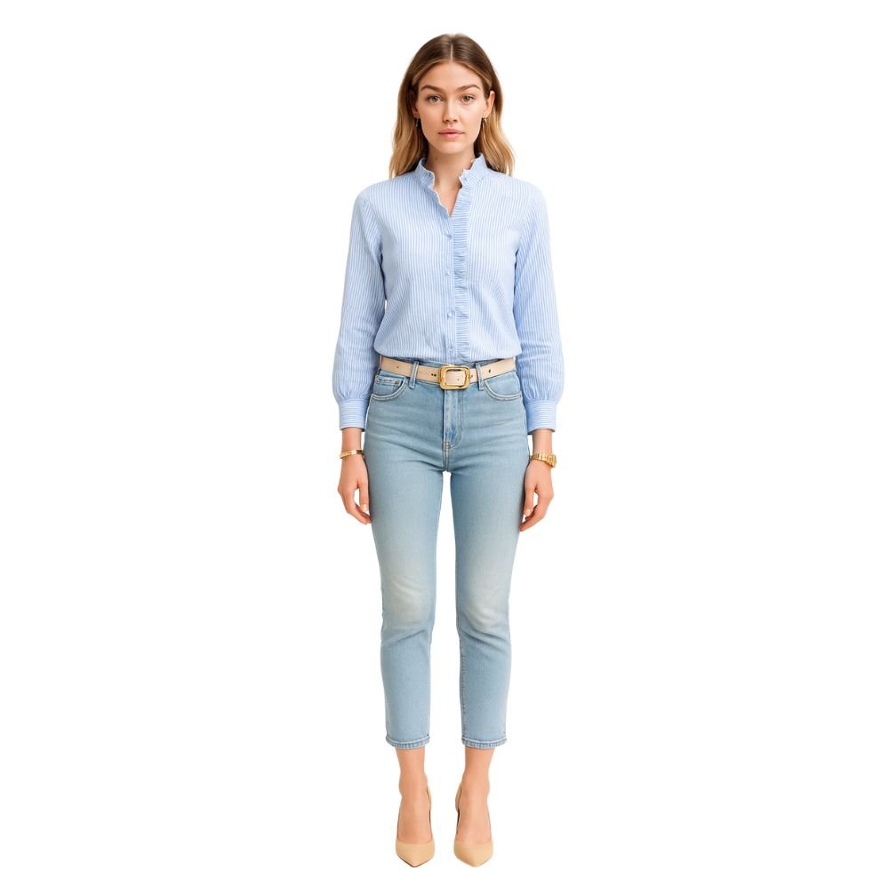 Woman wearing the Kouvr Shandee blue long sleeve ruffle blouse tucked into light wash jean