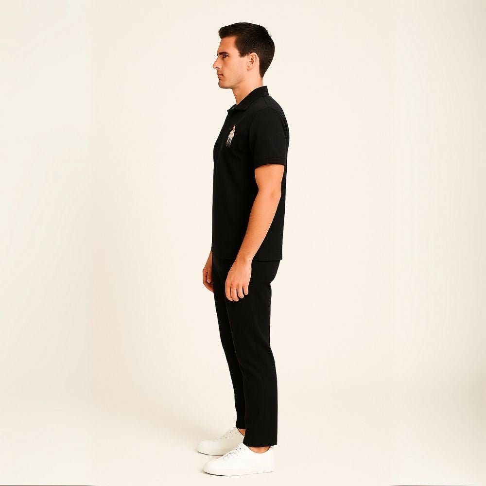 Man wearing the Kouvr Signature Black Polo Shirt with black trousers