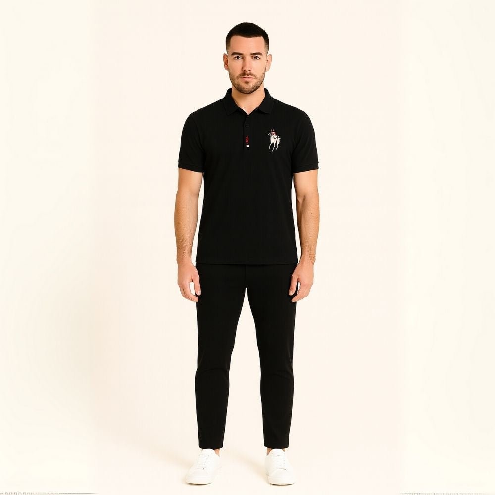 Man wearing the Kouvr Signature Black Polo Shirt with black trousers