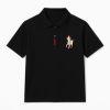 Man wearing the Kouvr Signature Black Polo Shirt with black trousers
