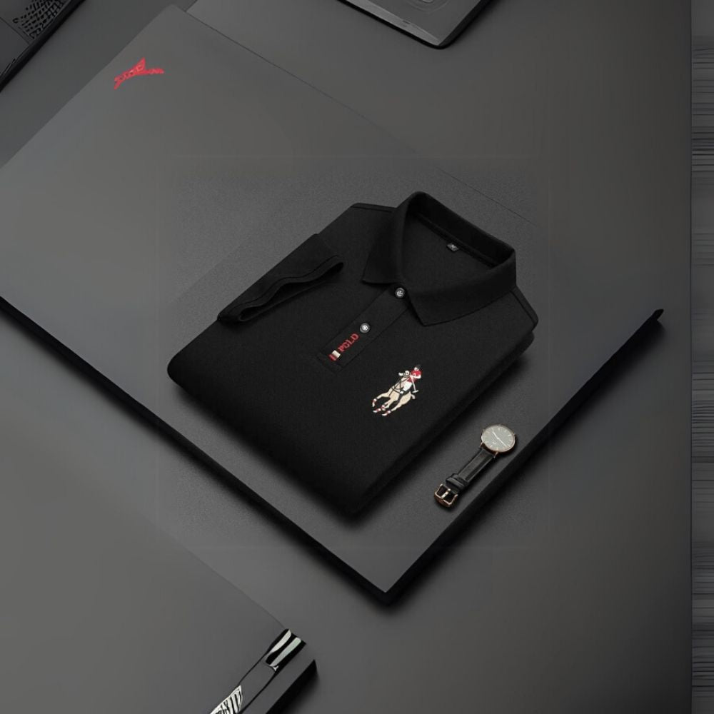 Black kouvr polo shirt with a brand logo on a dark surface