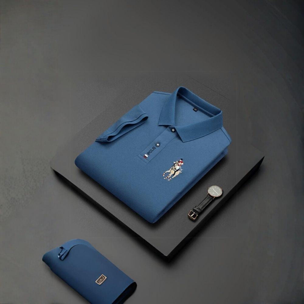 Blue kouvr polo shirt with a brand logo on a dark gray background