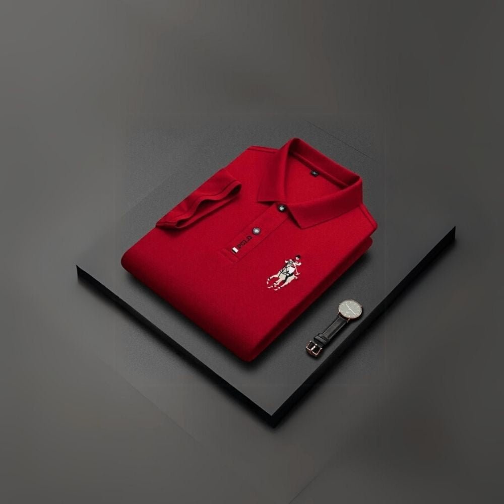 Red kouvr polo shirt with a brand logo on a dark surface