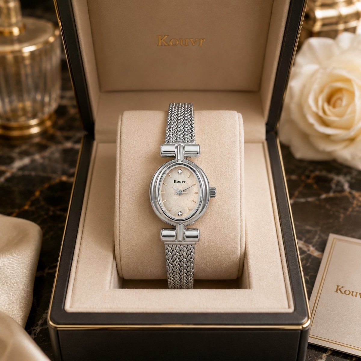 Luxury Kouvr women's silver oval dress watch with mother of pearl dial displayed elegantly in a premium storage box