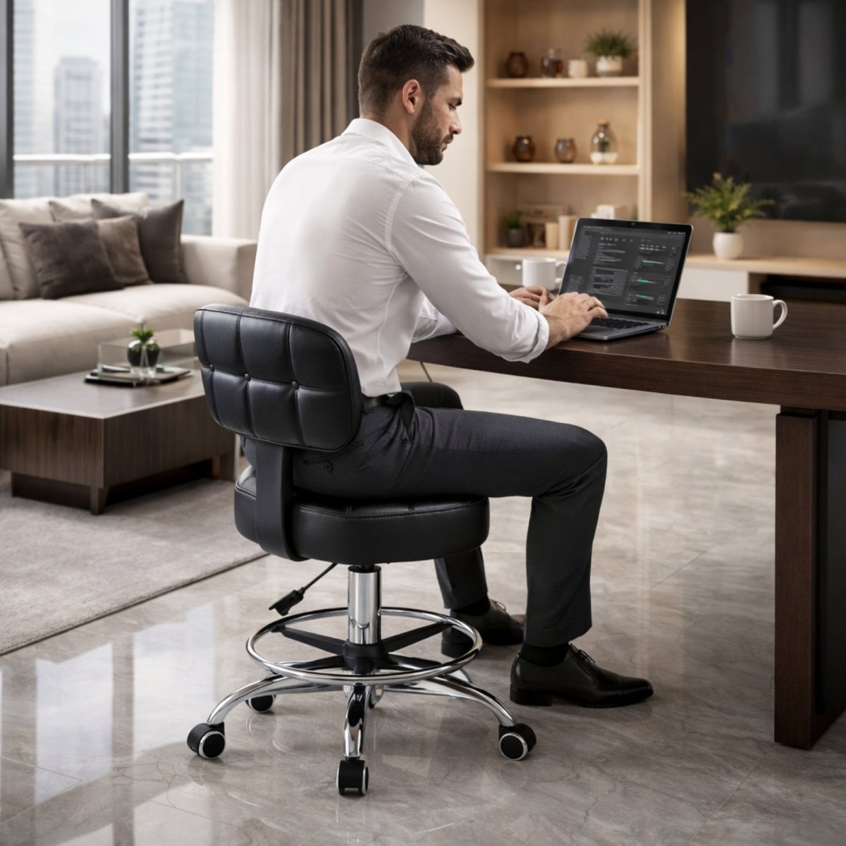 A man in professional attire working on a laptop while seated on the Kouvr black leather swivel task chair at a dark wood desk in a luxury apartment.