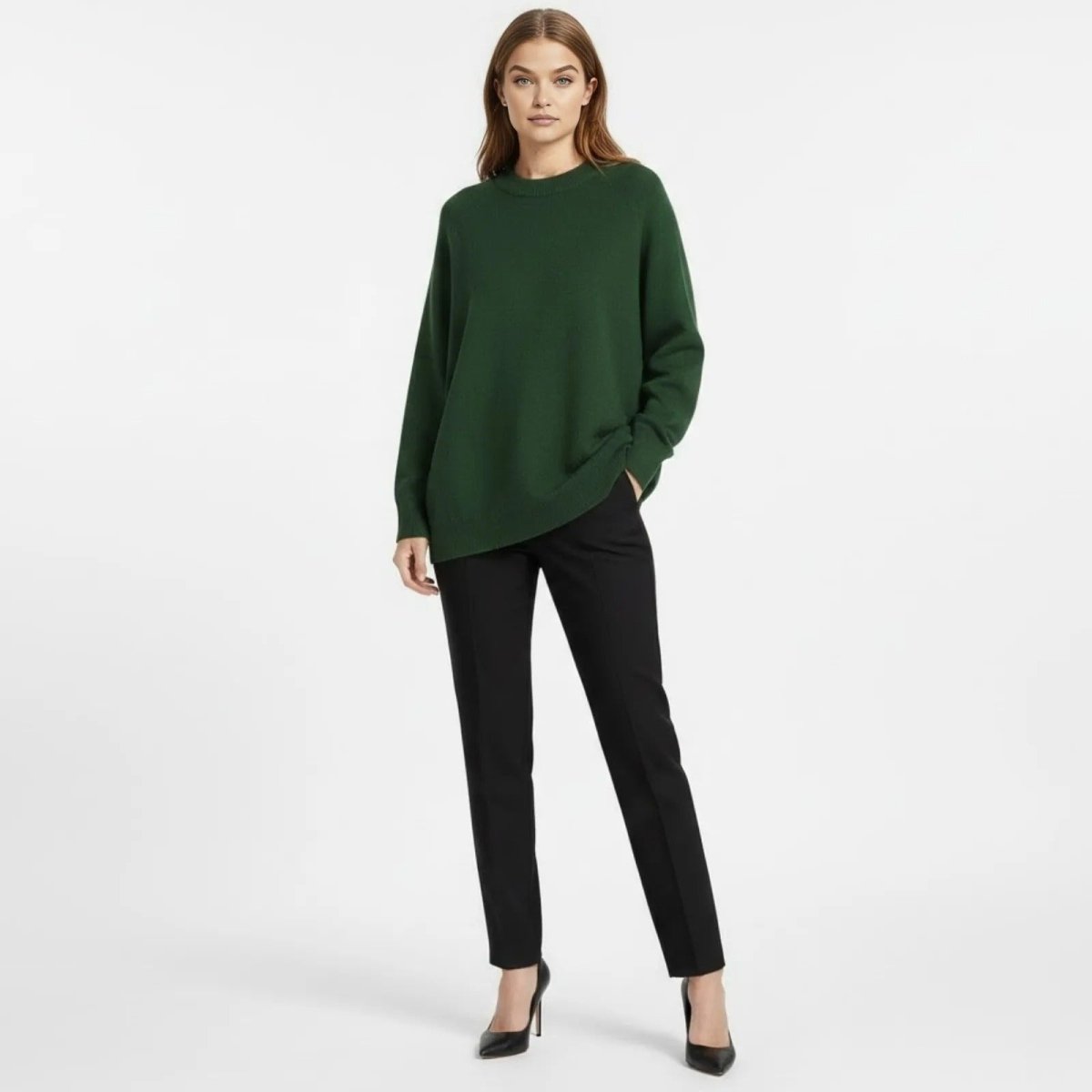 Model wearing the Tina Oversized Cashmere Blend Sweater in forest green, styled with black trousers, from Kouvr Fashion.