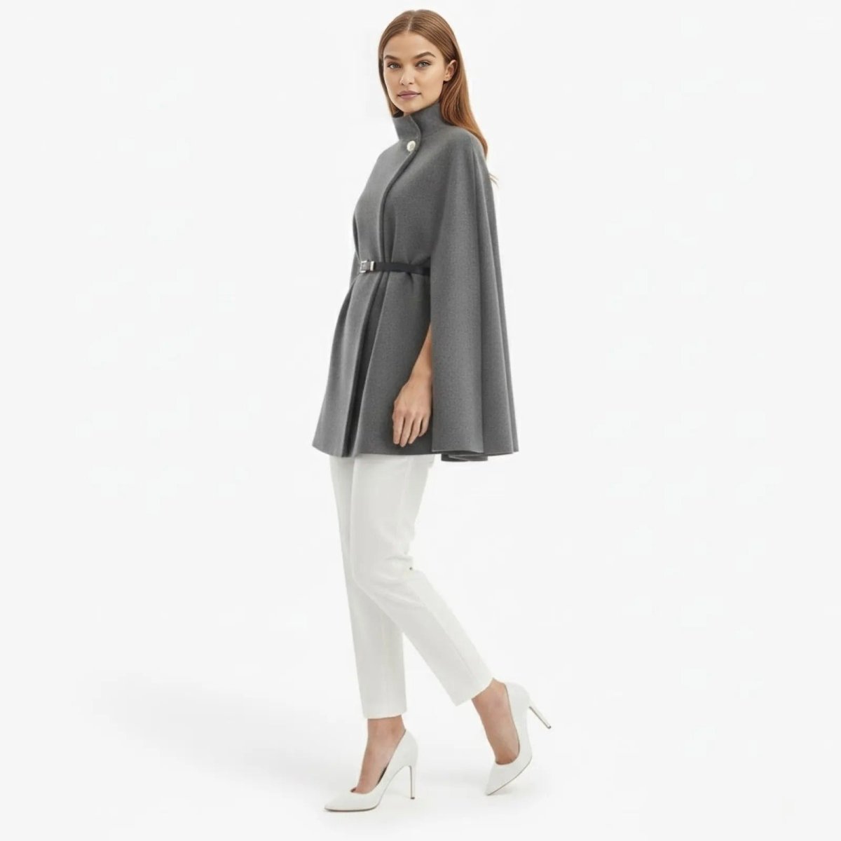 Side profile of a model walking in the elegant grey wool-blend Traci cape coat.
