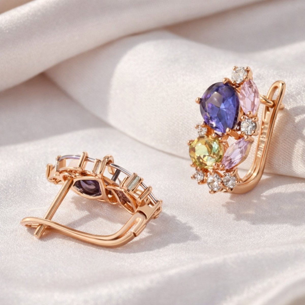 An open view of the Kouvr Vanya earrings, showing the intricate gemstone setting and the high-quality English lock closure mechanism.