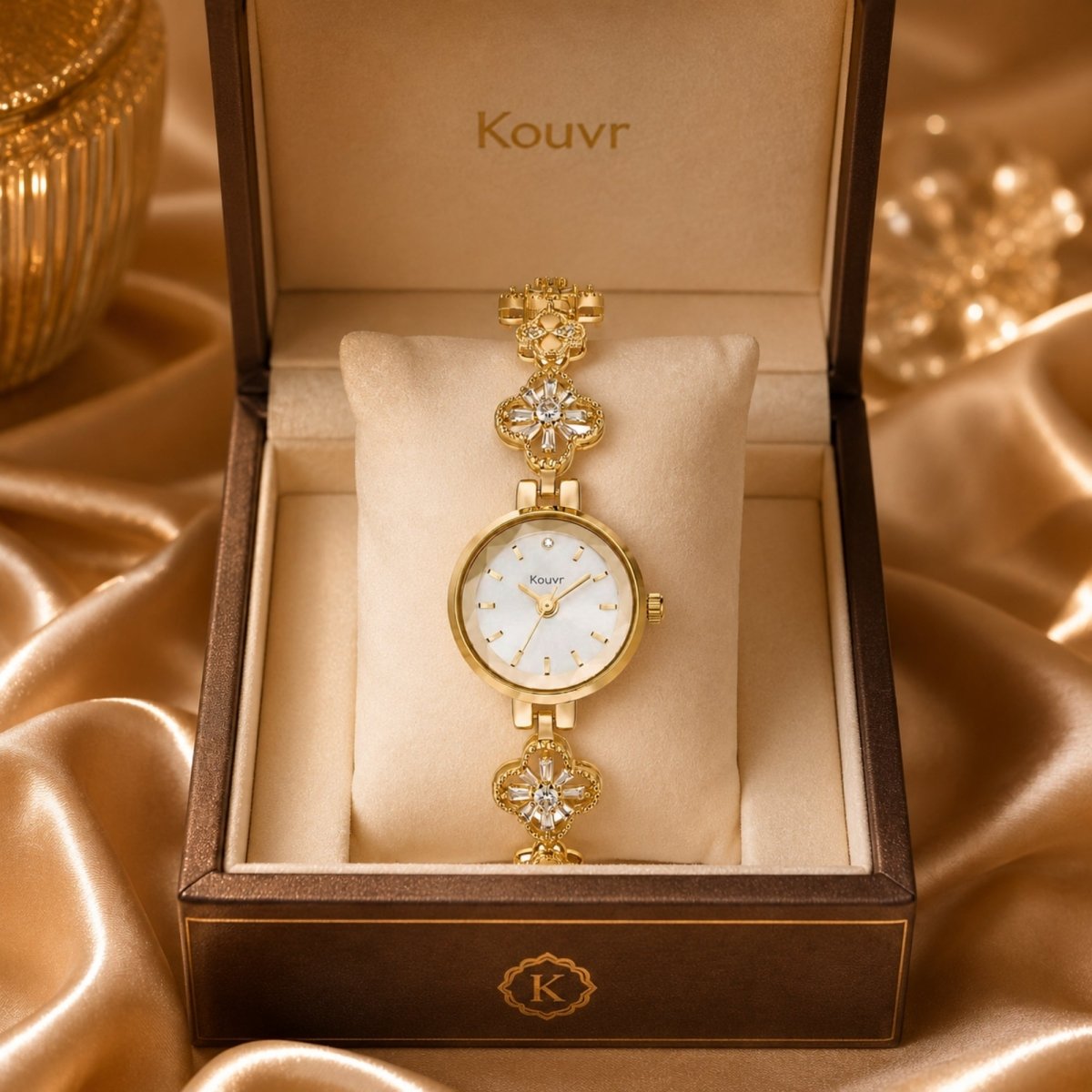 Kouvr vintage style gold bracelet watch for women displayed in a brown luxury presentation box on gold silk.