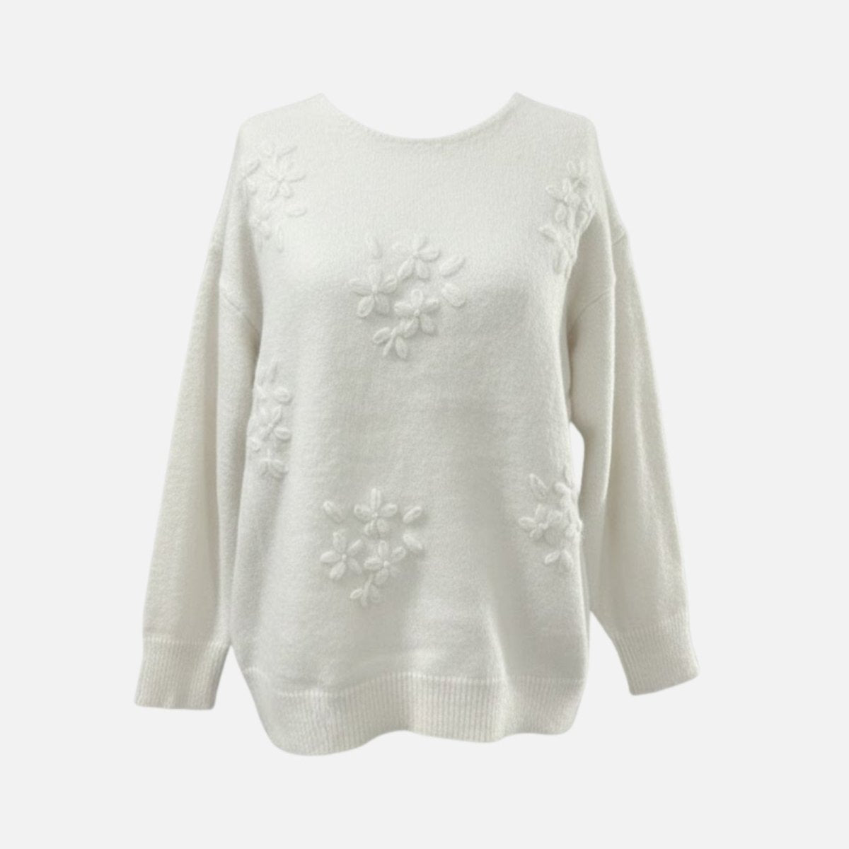 Product-only shot of the Kouvr white sweater showcasing the 3D floral appliqué on the front.

