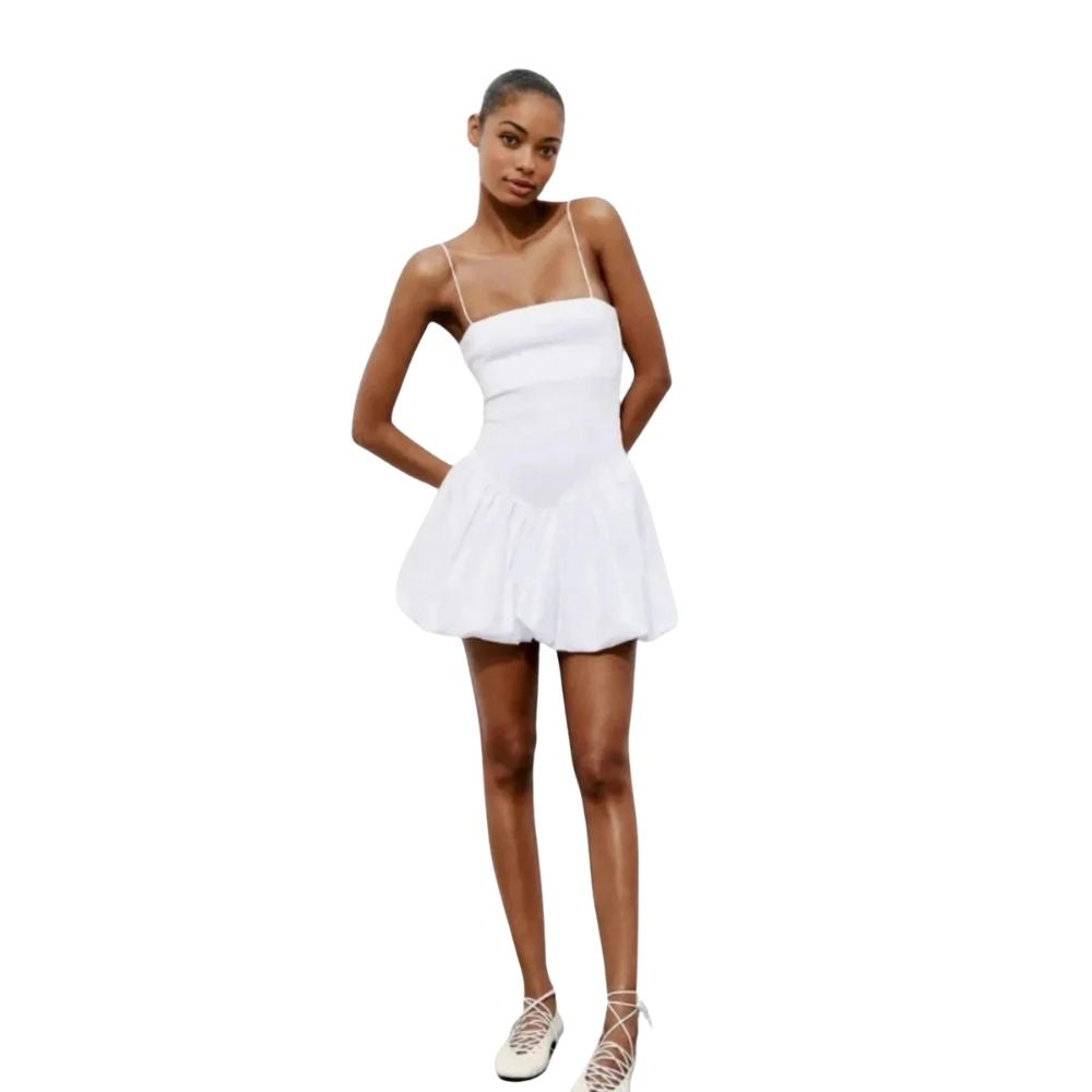 Model wearing the Kouvr white bubble hem mini dress with spaghetti straps