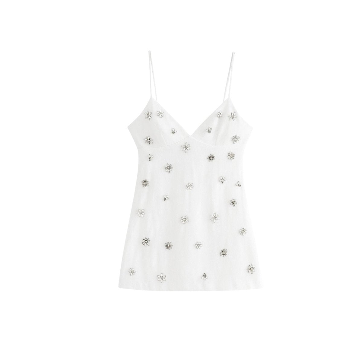 Back view of model wearing a white embellished party top, displaying the adjustable spaghetti straps and ponytail styling.