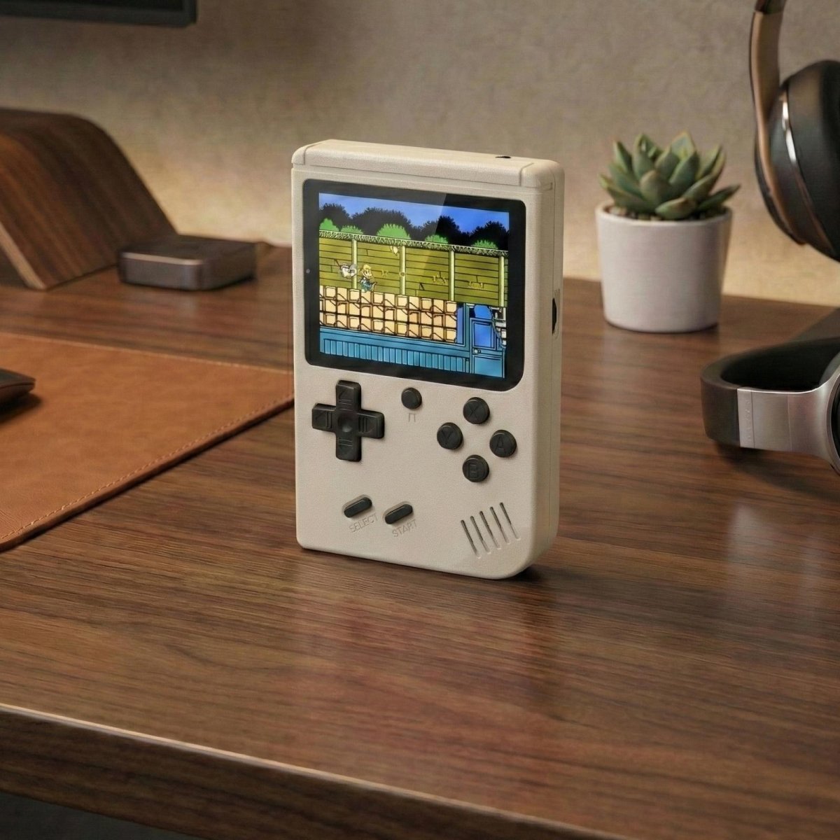 White Kouvr retro handheld game console with a 3-inch color screen showing a classic 8-bit game.