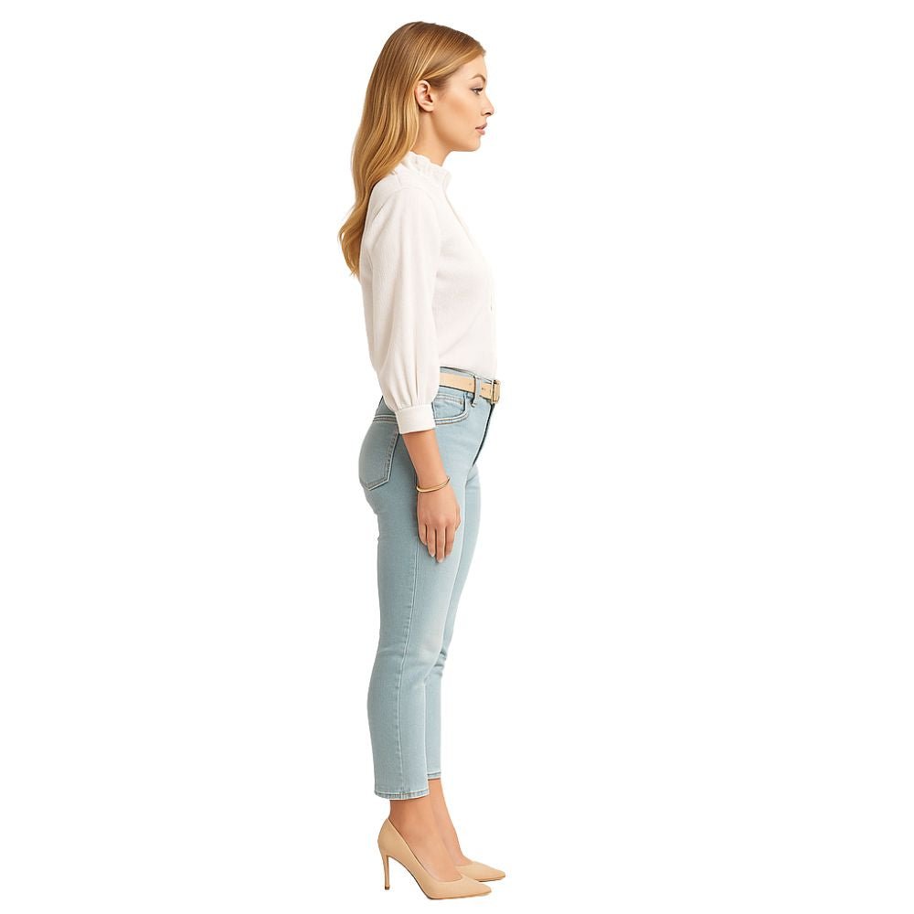 Model wearing the Kouvr women's white textured blouse with ruffle collar, paired with light wash jeans
