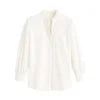 Model wearing the Kouvr women's white textured blouse with ruffle collar, paired with light wash jeans