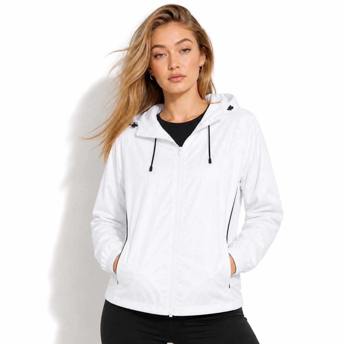 Woman wearing Kouvr white lightweight hooded windbreaker jacket with black drawstrings zip up front