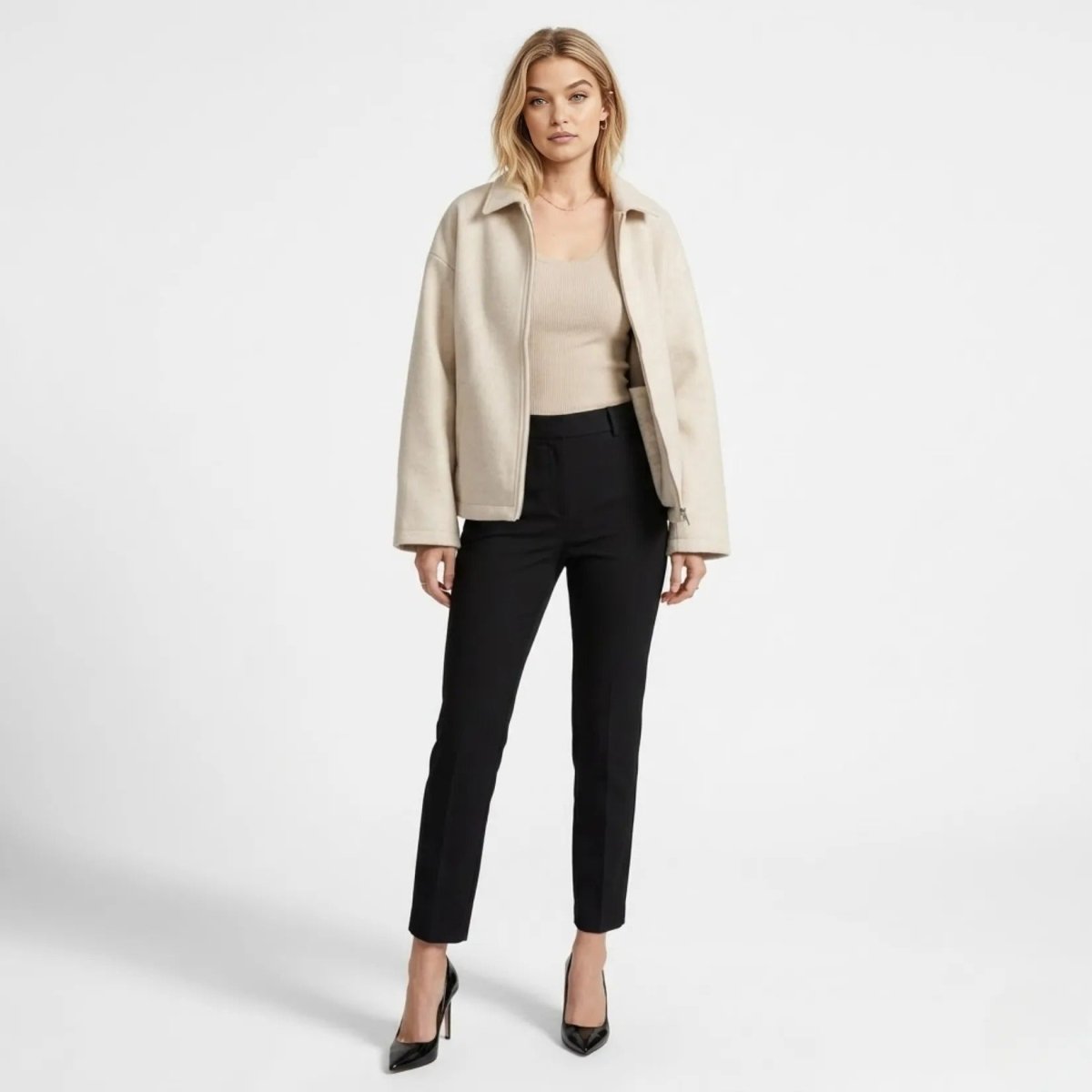 Front view of model wearing Kouvr white wool blend cropped zip jacket paired with black tailored pants for a quiet luxury aesthetic