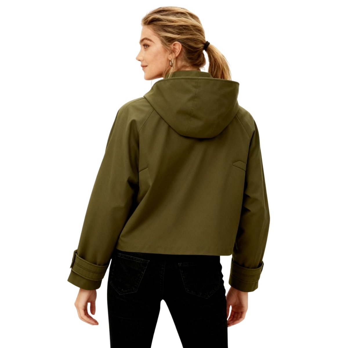 woman styling the Kouvr army green lilibeth jacket with black pants and white sneakers.