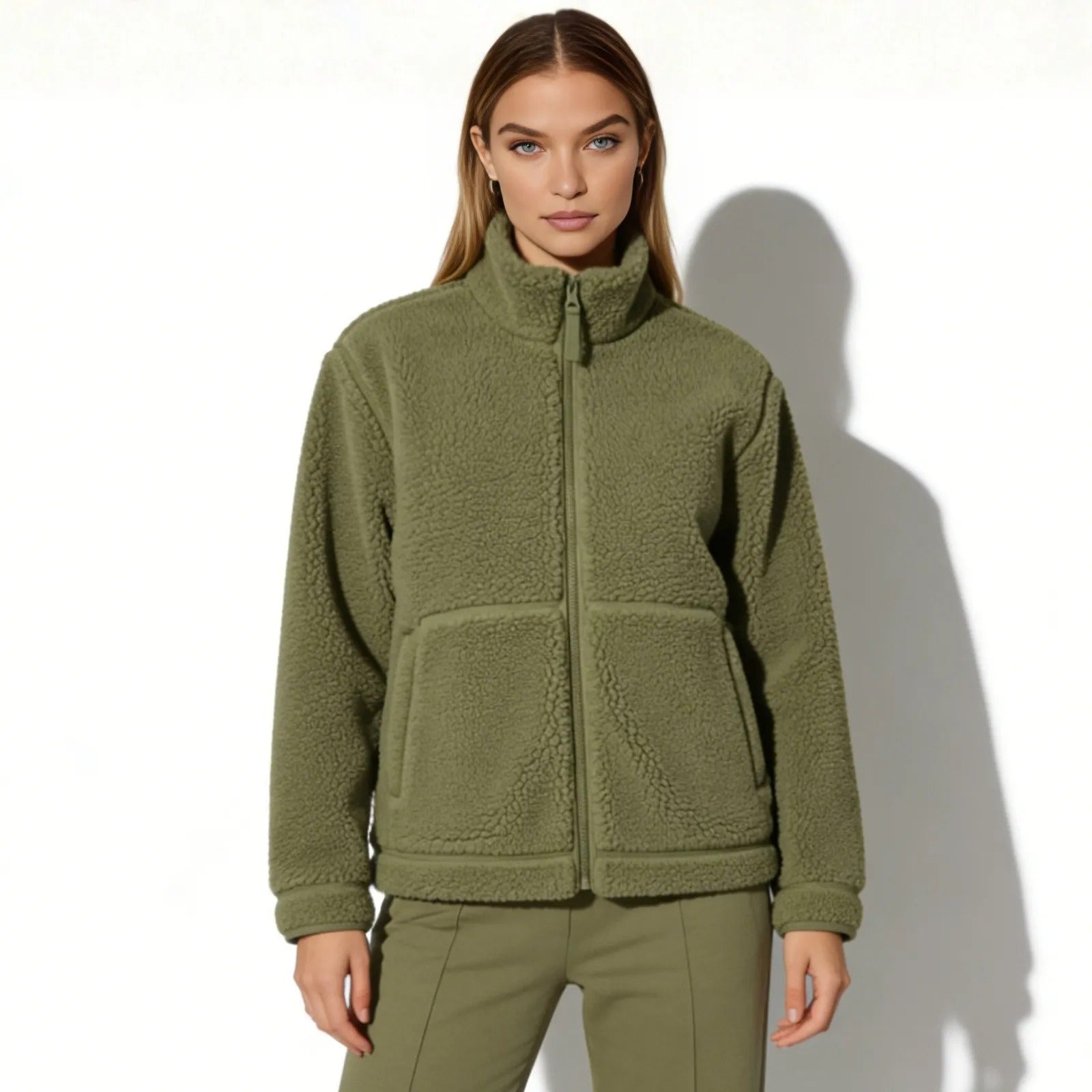 Model wearing the Kouvr women's army green sherpa fleece full-zip jacket, front view.