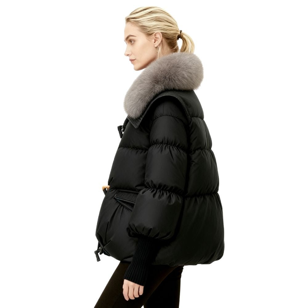 Black kouvr puffer jacket with fur hood worn by a person on a white background