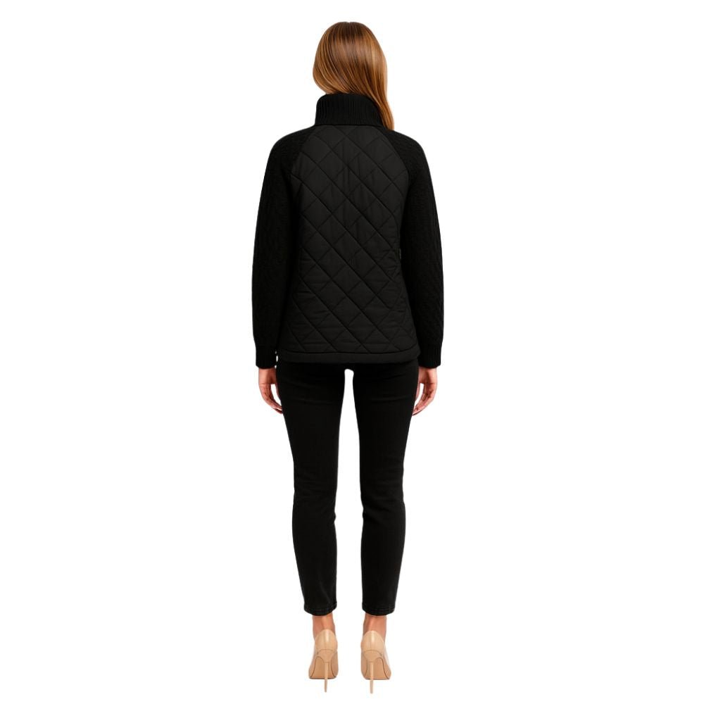 Woman wearing the Kouvr Fashion black quilted jacket with cable knit sleeves and a funnel neck collar, styled for a casual city look