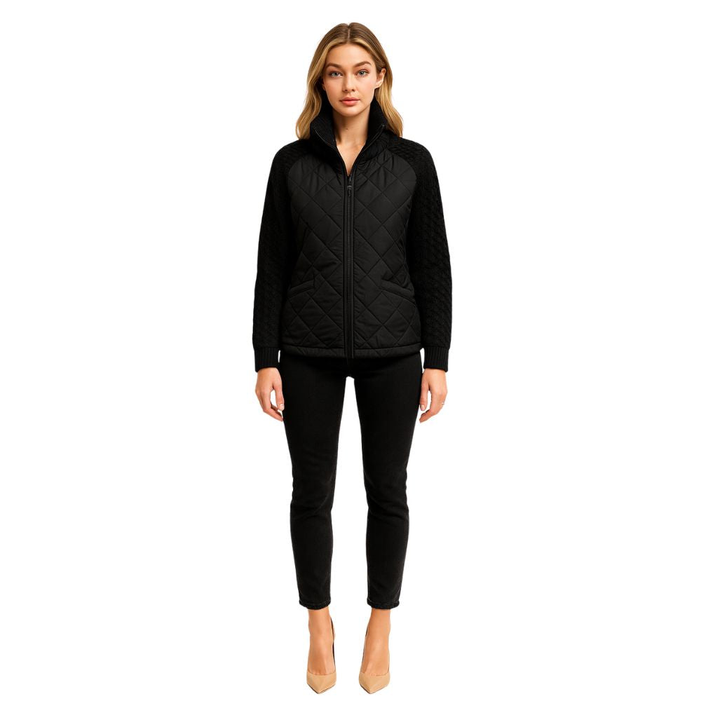 Woman wearing the Kouvr Fashion black quilted jacket with cable knit sleeves and a funnel neck collar, styled for a casual city look