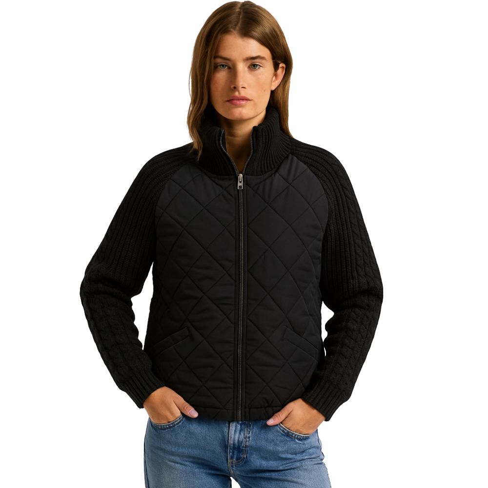 Woman wearing the Kouvr Fashion black quilted jacket with cable knit sleeves and a funnel neck collar, styled for a casual city look