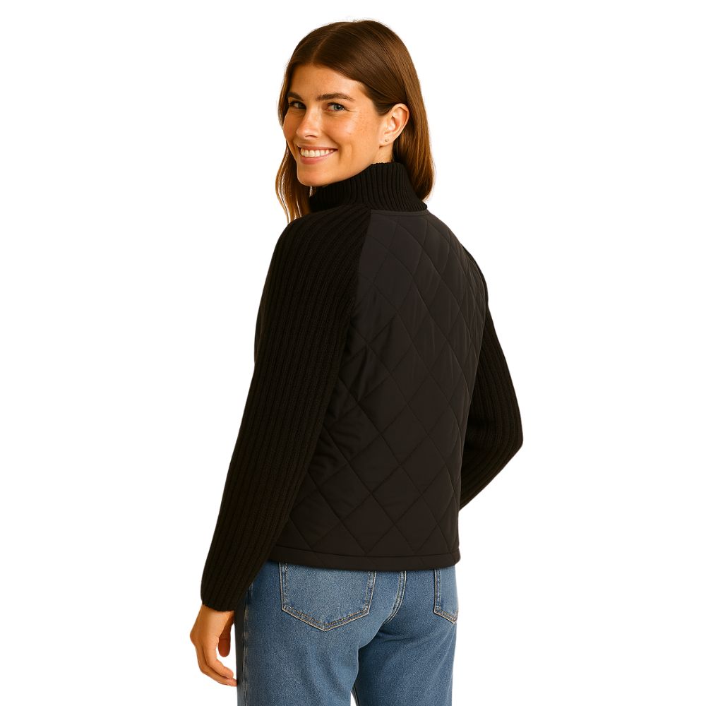 Woman wearing the Kouvr Fashion black quilted jacket with cable knit sleeves and a funnel neck collar, styled for a casual city look