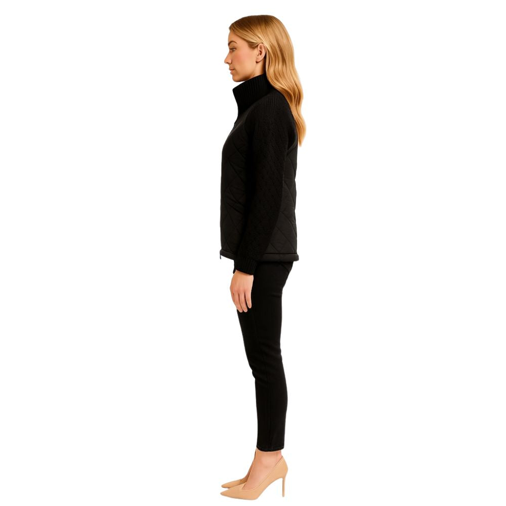 Woman wearing the Kouvr Fashion black quilted jacket with cable knit sleeves and a funnel neck collar, styled for a casual city look