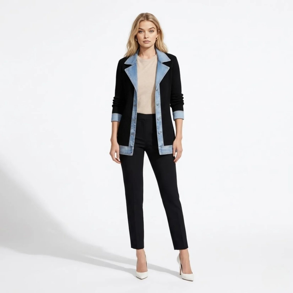 Model wearing Kouvr affordable luxury black ribbed knit cardigan jacket with blue denim collar and trim, paired with black tailored trousers.