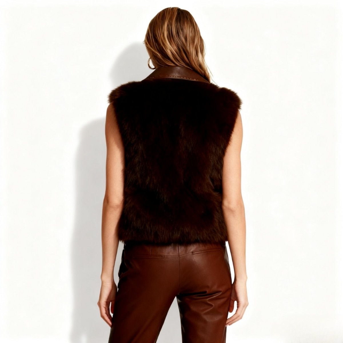 Person wearing a Dark brown Kouvr fur vest  on a white background