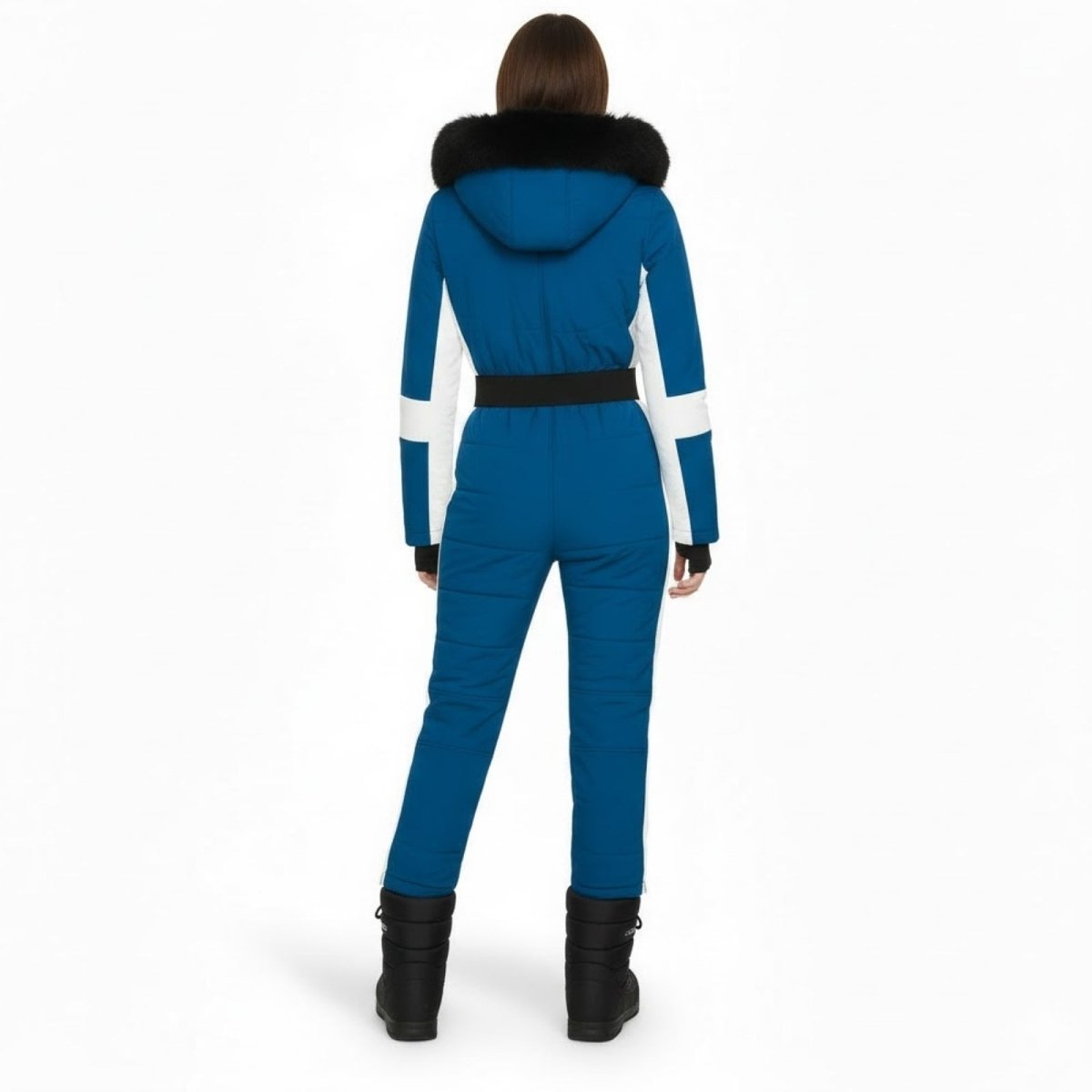 Back view of a woman in the Kouvr Fashion blue hooded ski jumpsuit, showing the black belt and color block details.
