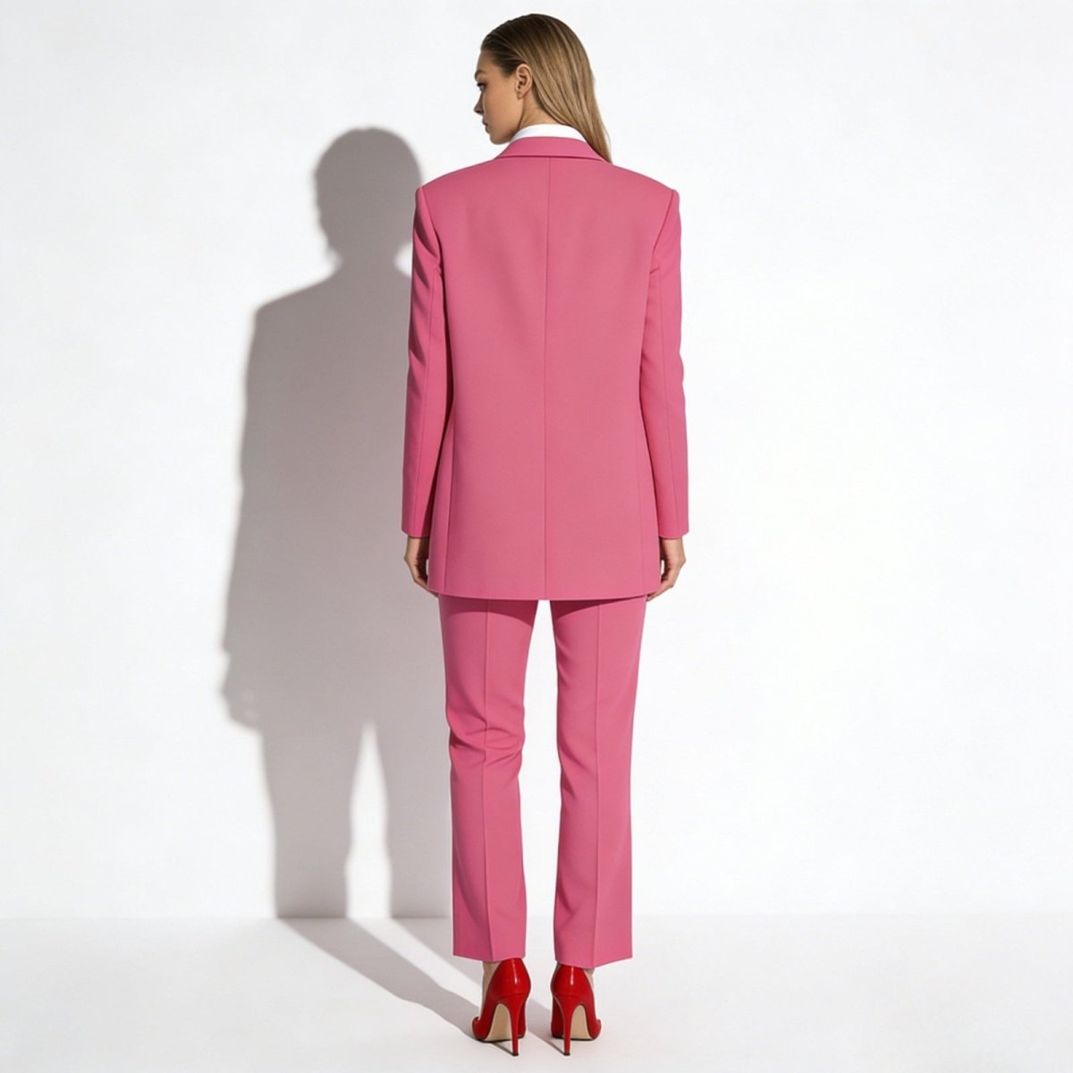Back view of the Kouvr single-breasted fuchsia blazer displaying its clean lines, center vent, and expert tailoring.