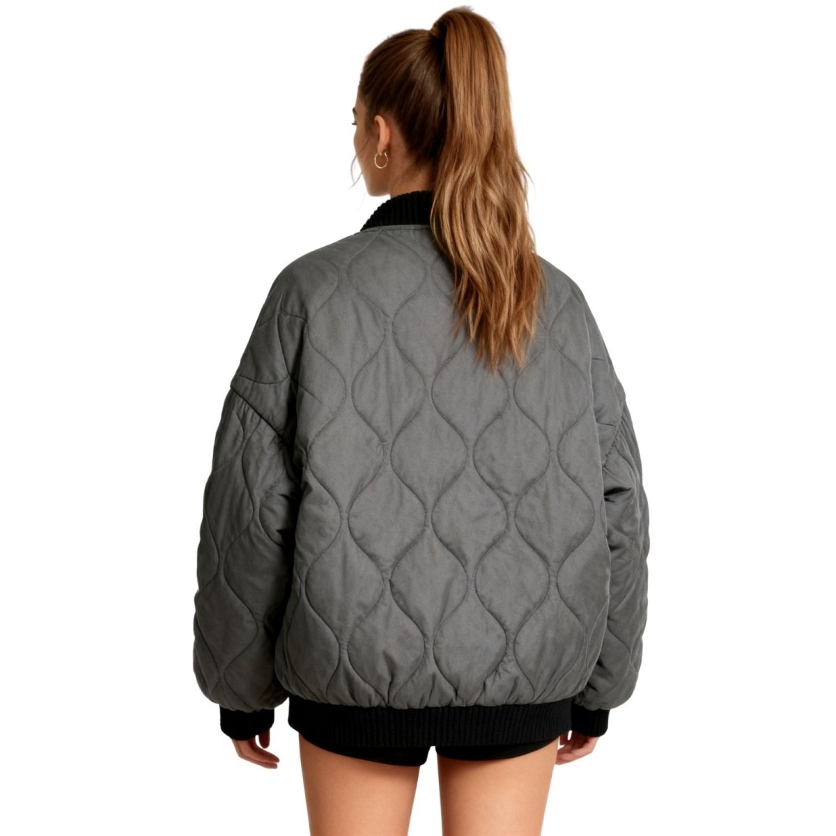 Model styling the Kouvr oversized quilted bomber jacket.