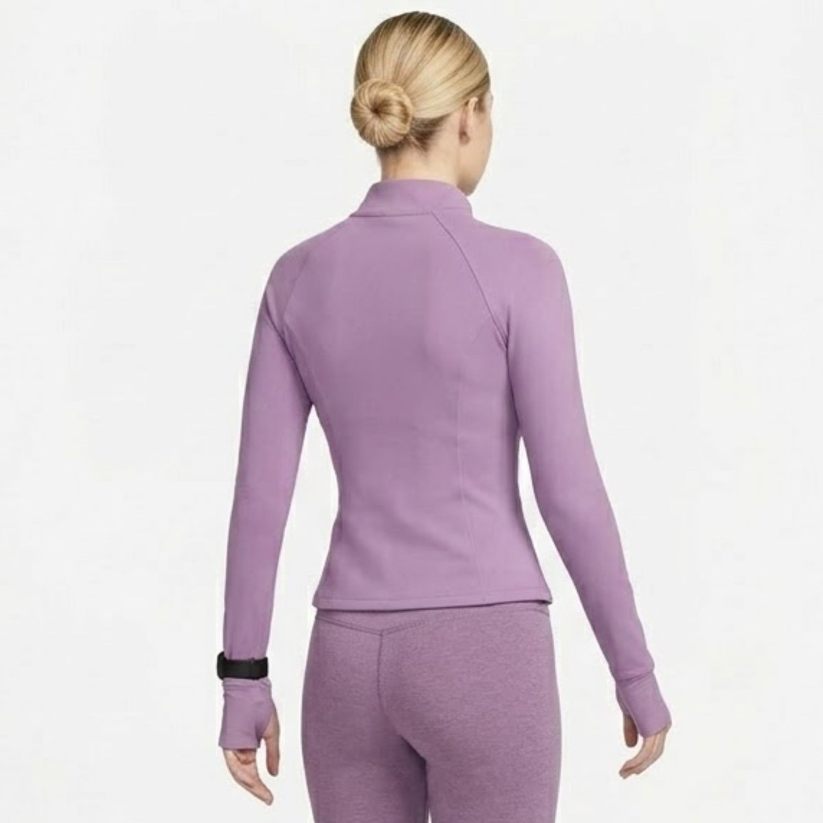  Back view of woman in Kouvr purple athletic long sleeve workout jacket highlighting contoured seams