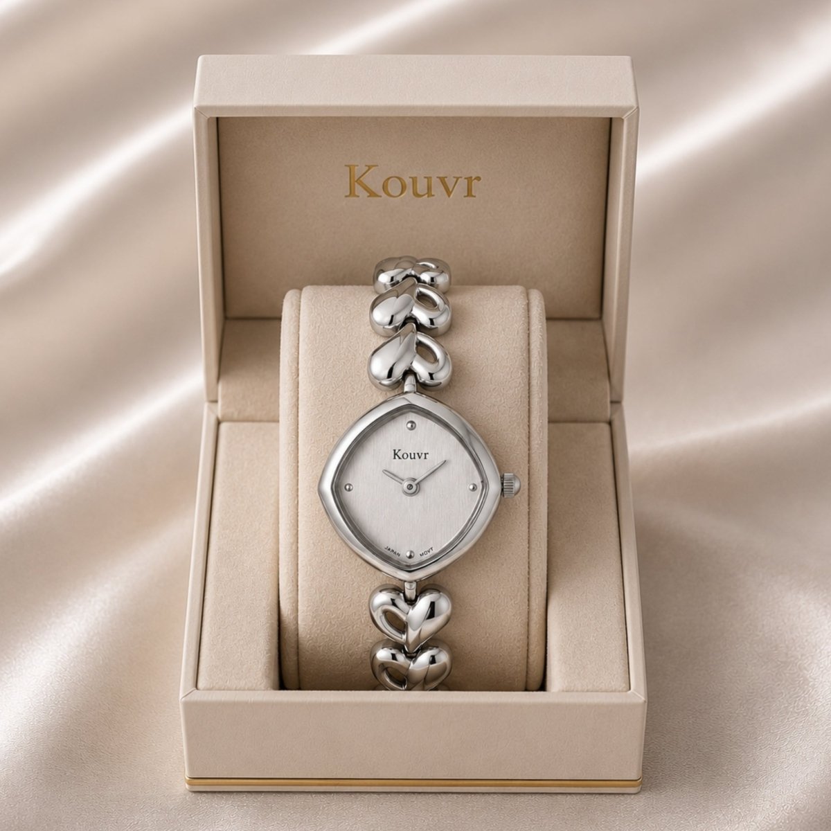 Top view of the elegant Kouvr women's silver stainless steel watch with romantic heart link bracelet resting softly inside a luxury presentation box.