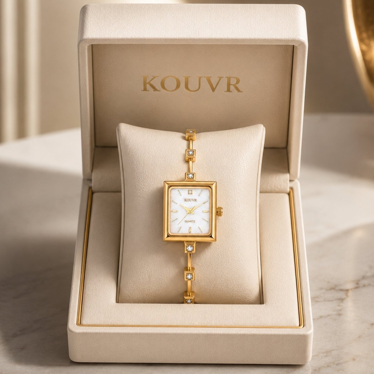 Kouvr women's vintage gold square watch with mother of pearl dial presented in a beige luxury display box
