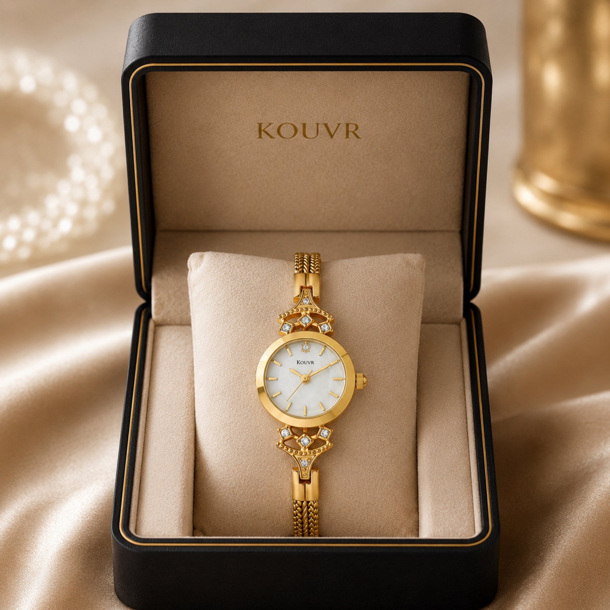 Kouvr women's vintage gold watch with pearl dial presented on a plush cushion inside a luxury black gift box