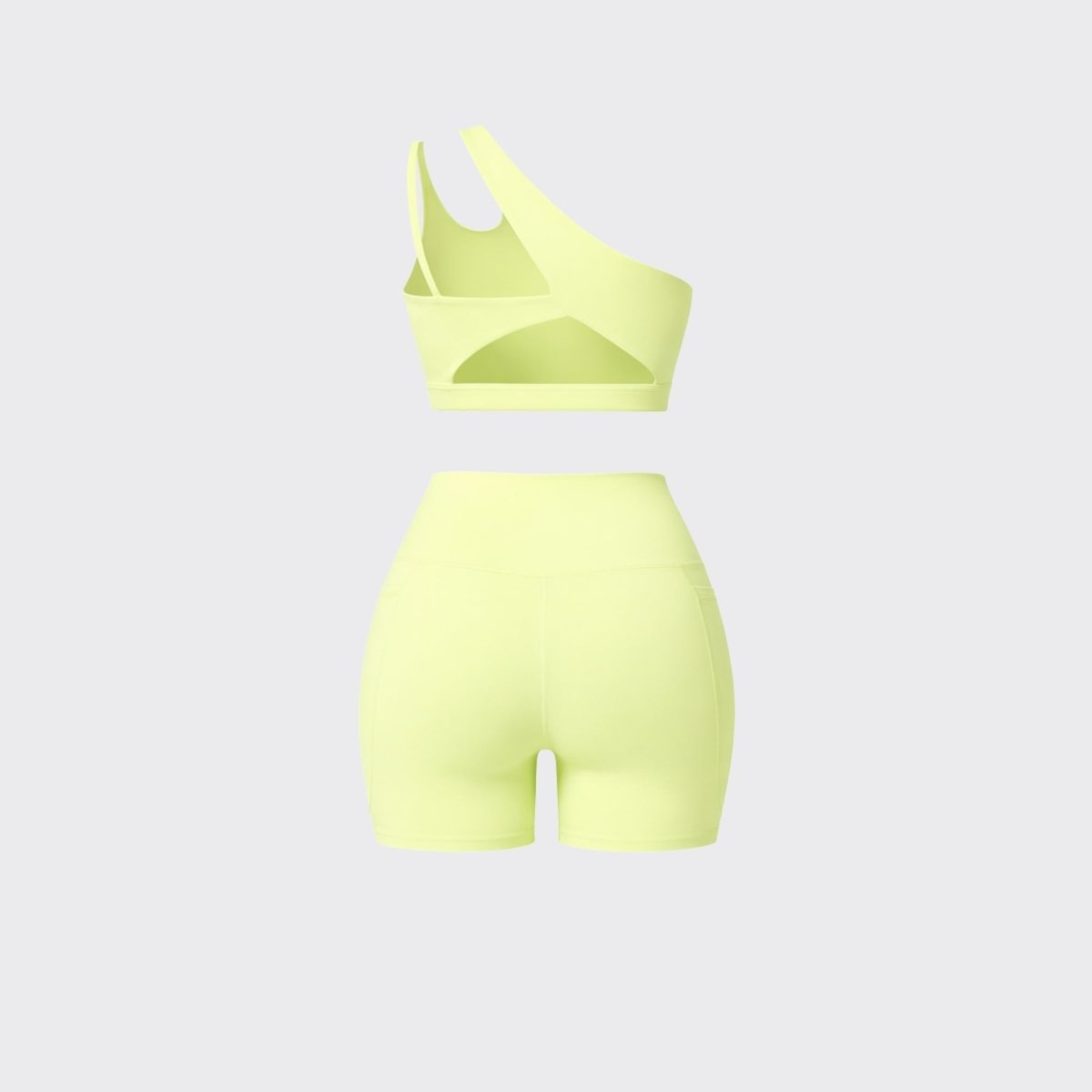 Back flatlay view of Kouvr yellow two piece workout set detailing back cutouts on crop top 