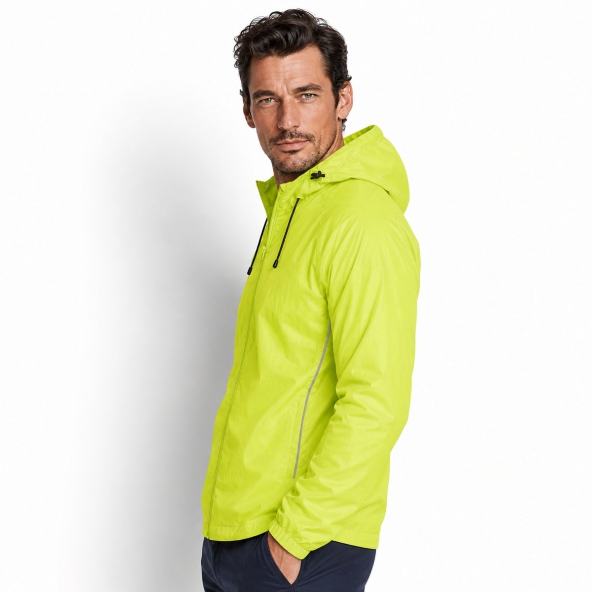 Side view of male model in Kouvr yellow water-resistant activewear jacket highlighting raglan sleeves