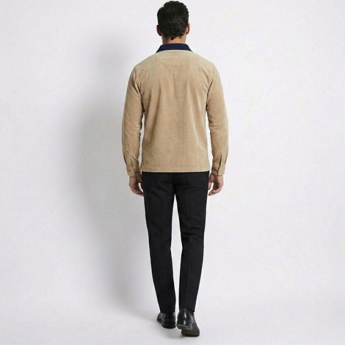 Back view of the Kouvr Zian Corduroy Polo in khaki, showing the fabric texture and fit across the shoulders.
