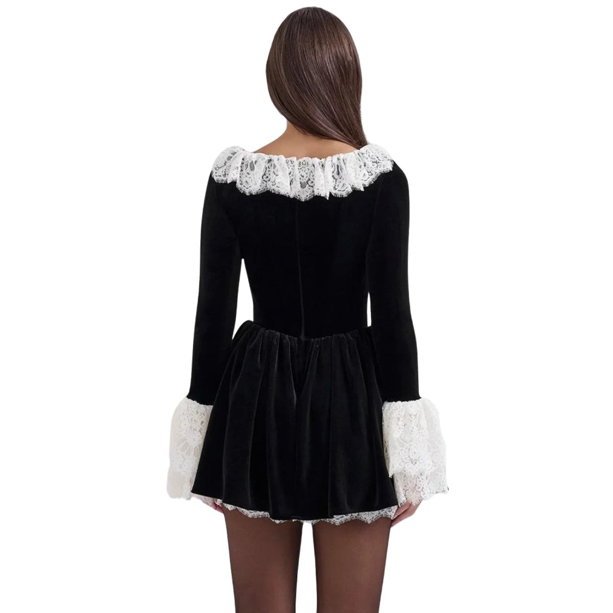Back view of a woman in a long-sleeve black velvet mini dress with a lace-trimmed square neckline.